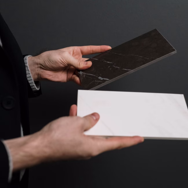 white and black marble tiles in hands